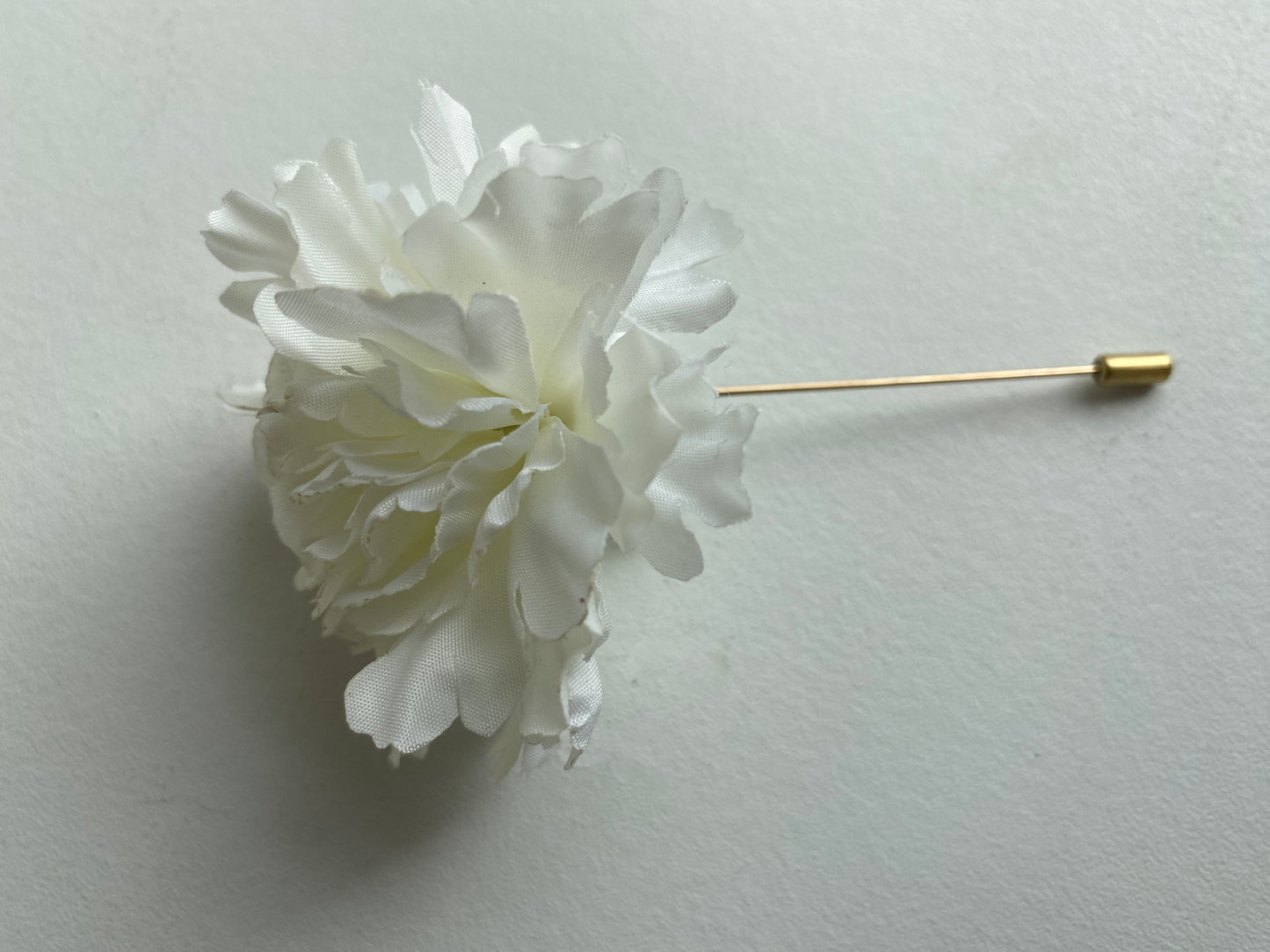 white carnation buttonhole lapel pin wedding formal occasion