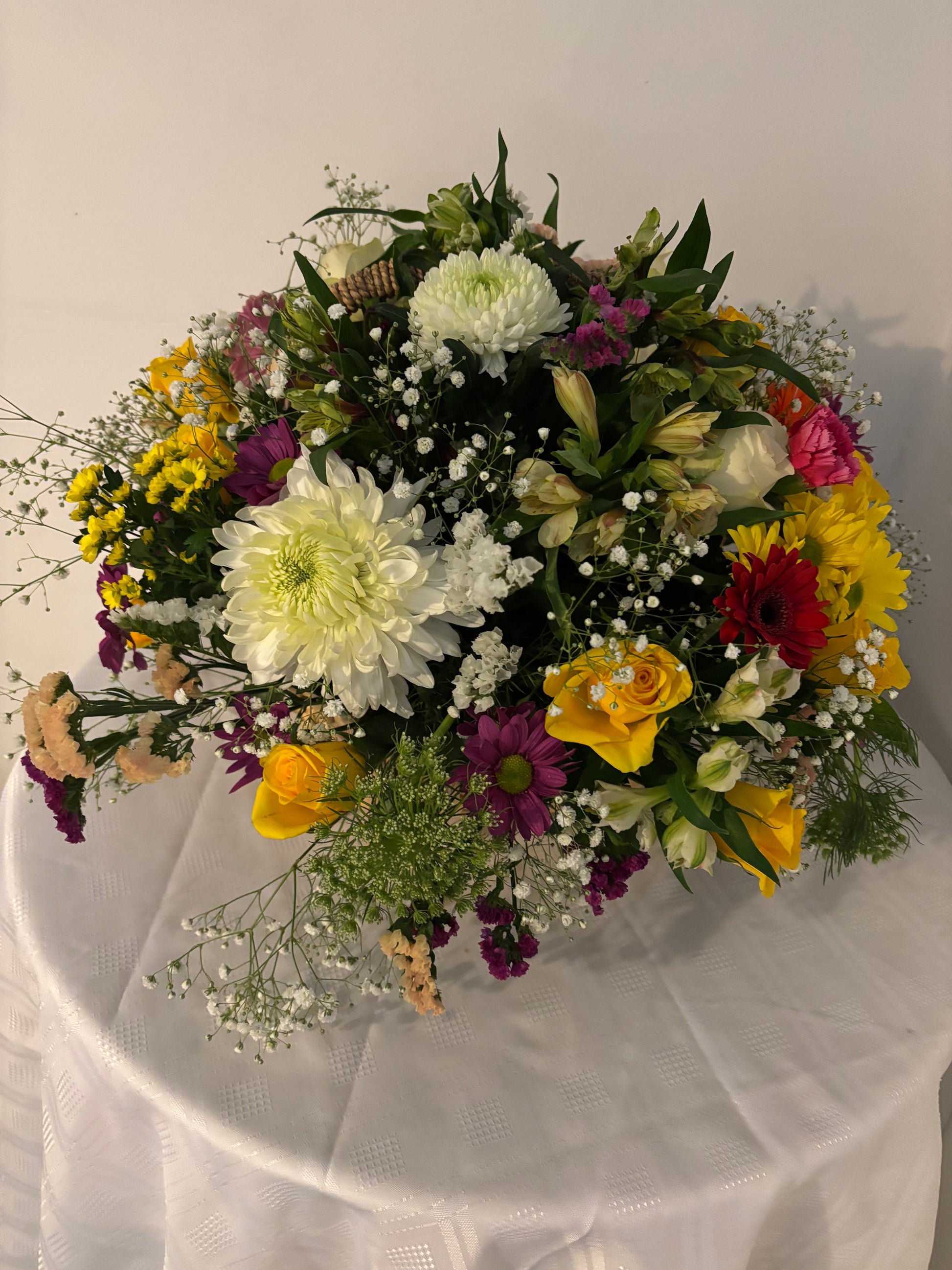 Mixed colour fresh flowers arranged in a basket