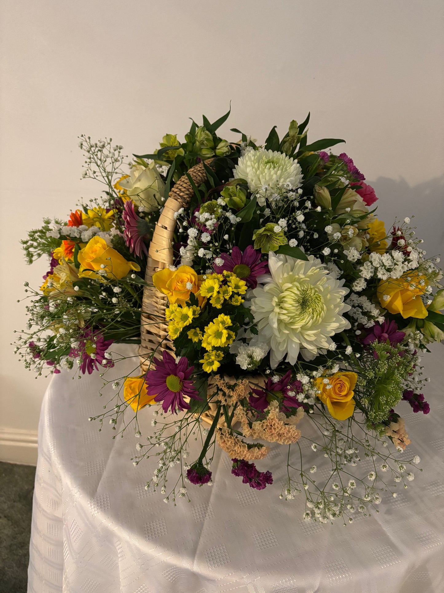 Fresh mixed flowers arranged in a basket