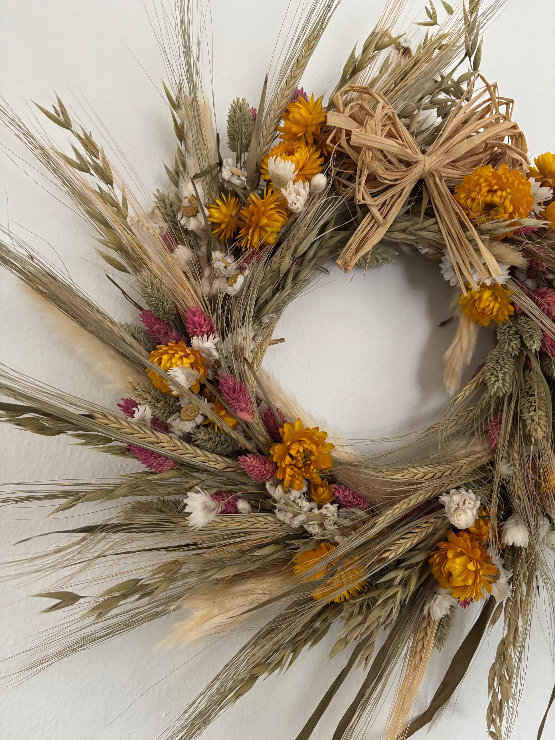 Natural dried flower wreath with bow view