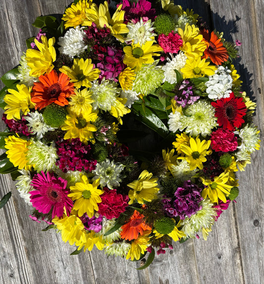 Round open mixed flower Wreath Funeral Tribute  - mixed colour flowers.