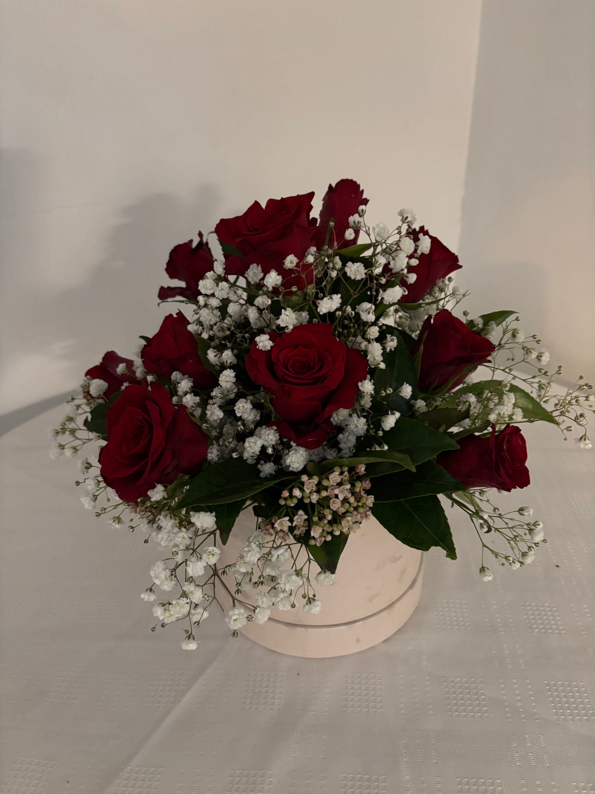 Red Roses and Gypsophila arranged in a hat box