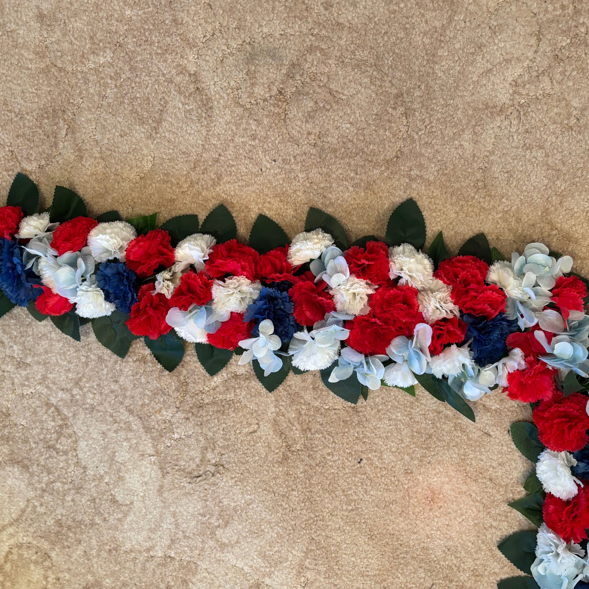 Close up of red white and blue flowers on cob sized garland
