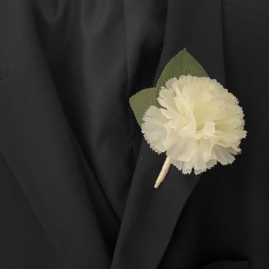 Cream carnation buttonhole with ribbon handle