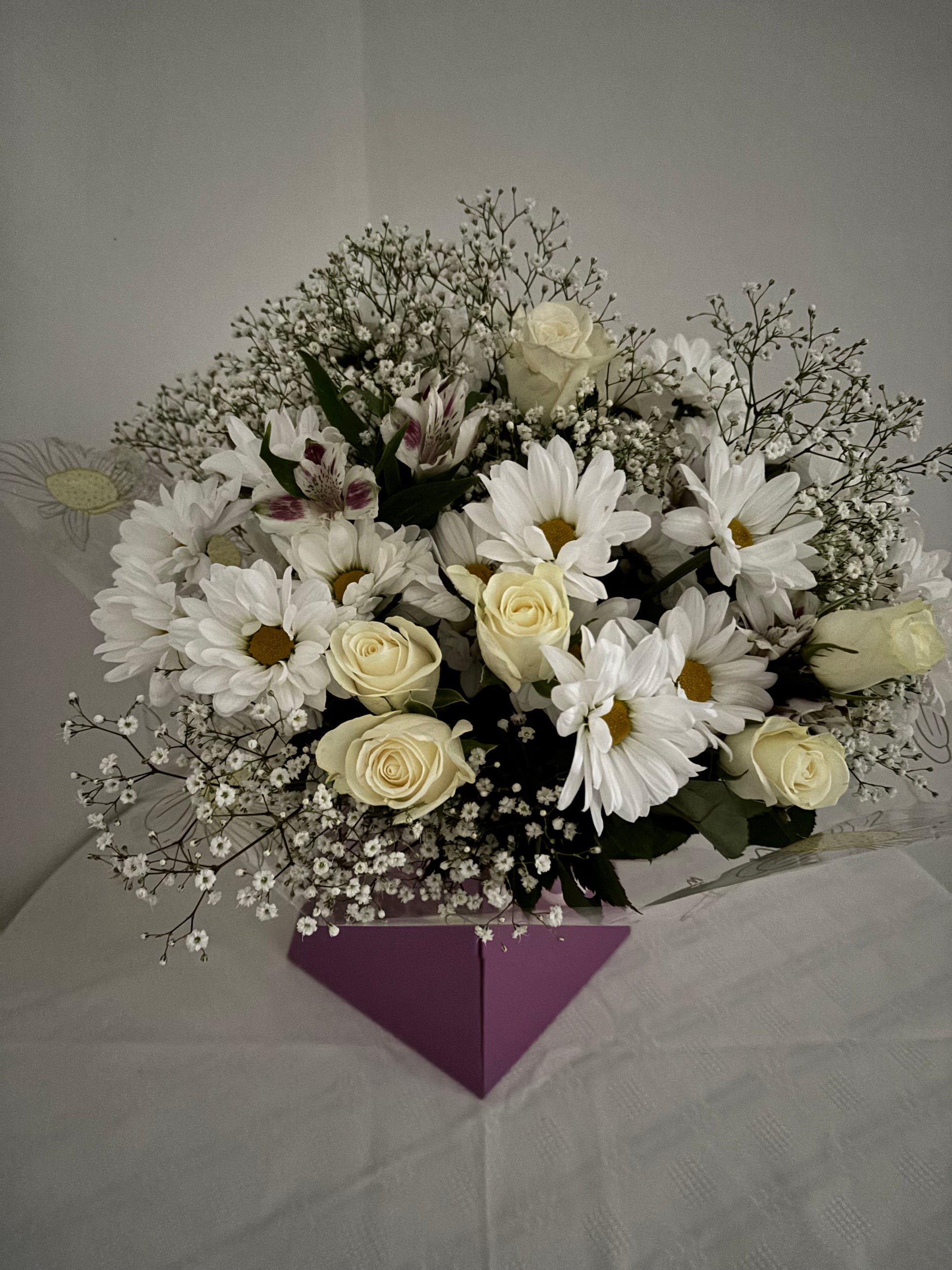 Fresh mixed flower bouquet of neutral shades of white and cream.