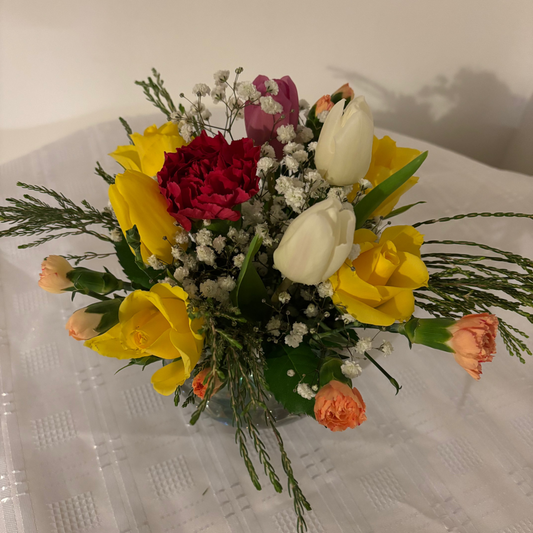 Glass globe vase mixed fresh flowers 