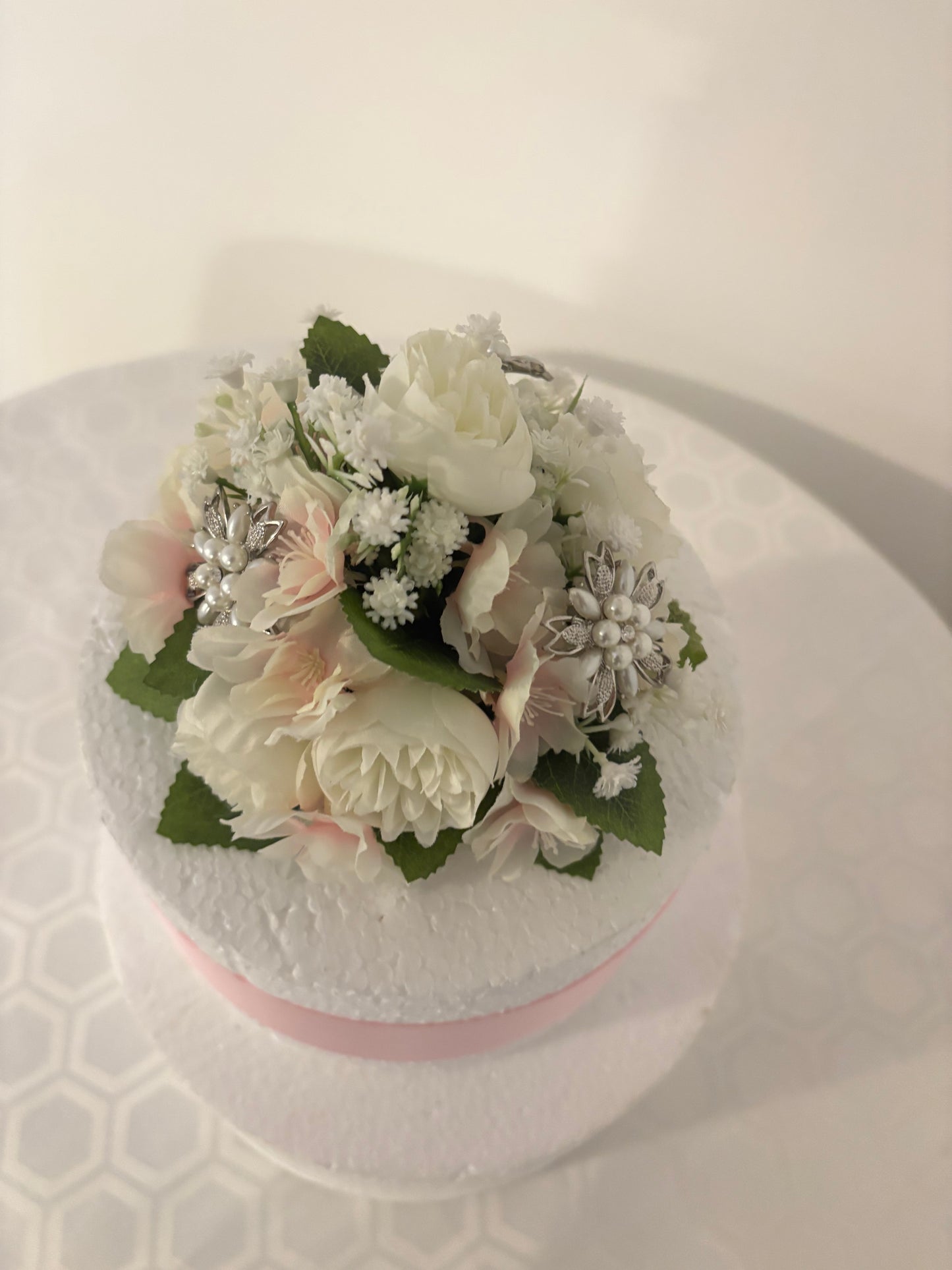 Cake topper. Silk ivory peonies, pale pink blossoms and gypsophila with pretty diamantés. Cake decoration.
