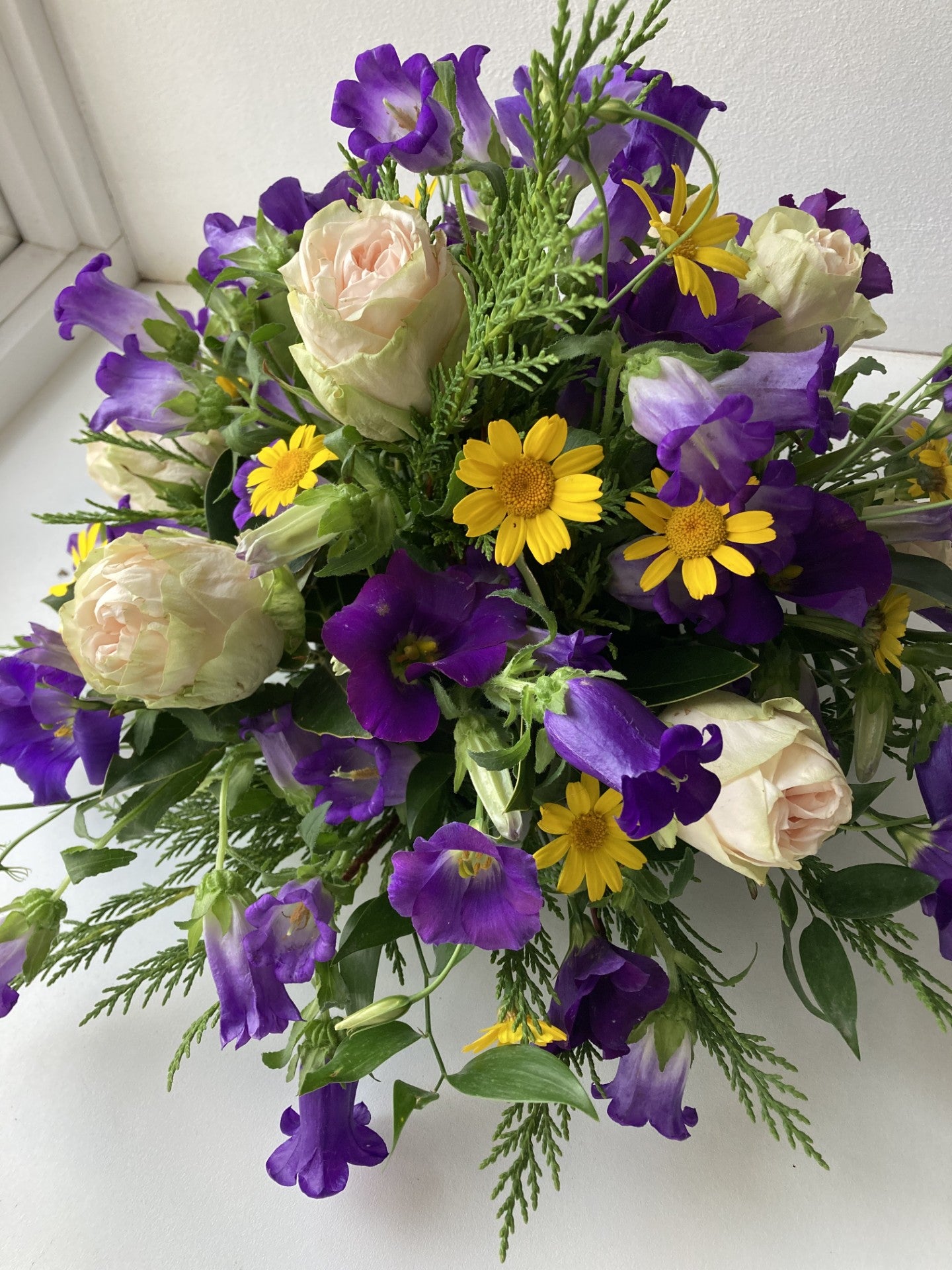 Blue and yellow round posy fresh flower funeral tribute