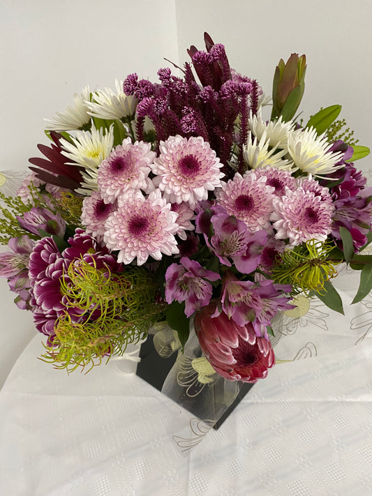 Hand Tied Bouquet of mixed fresh flowers in shades of mauve and lilacs