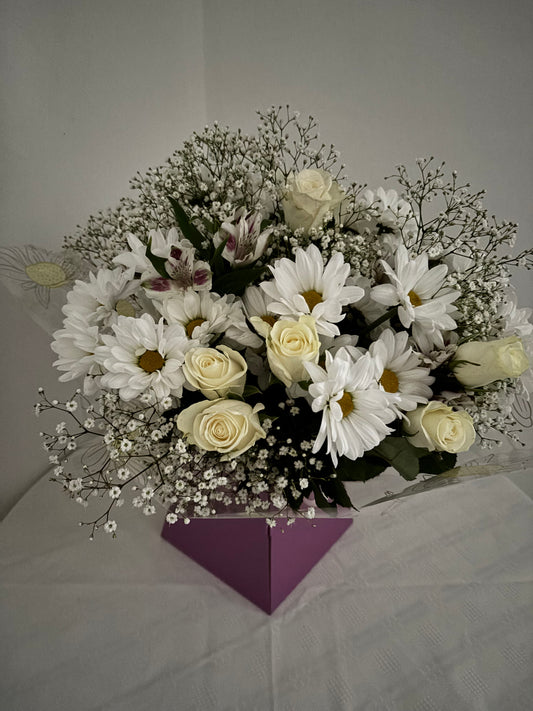 Fresh mixed flower bouquet of neutral shades of white and cream.