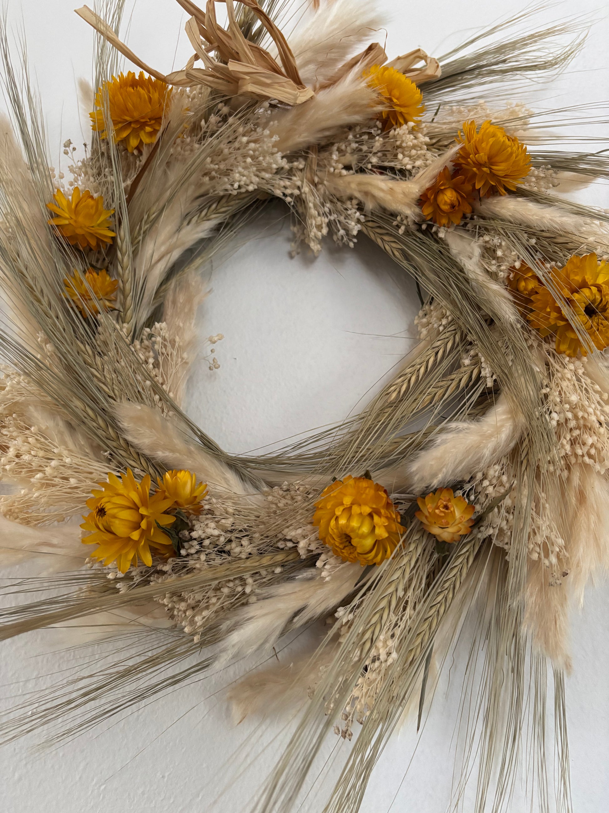 Hand made dried flower wreath in yellow ivory and pale greens